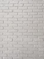 Detailed view of a white brick wall, showcasing its textured surface and uniform pattern. Simplicity and elegance of minimalistic interior design. Background with copy space and empty place for text photo