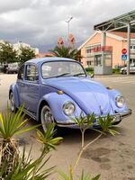 Vintage violet car on the street in summer. Old-fashioned nostalgia and retro style concept photo