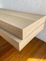Stacked wooden planks display an exquisite blend of natural texture and modern design. Warm tones and linear grain pattern bring elegance and simplicity to this architectural detail photo