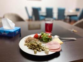 Homely meal is set on a dark wooden table, combining nutritious ingredients to create a comforting dining experience. The blurred background adds depth to the image photo