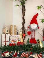 Christmas decor with a cute snowman toy and Christmas tree branch. Holidays and decorations concept photo