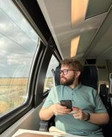 Man traveler enjoying a serene view from a train window. Calm and reflection during a peaceful journey photo