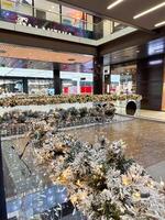 Close-up shot captures a beautifully frosted garland adorned with twinkling lights in Christmas festive indoor setting. Warm glow creates a magical atmosphere, perfect for the holiday season photo