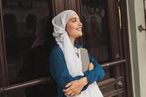 Young muslim girl wears hijab with diary book. Islamic student and knowledge concept. photo