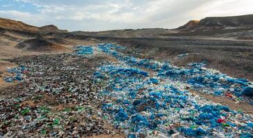 Plastic bottles and various garbage from hotels in the wild, Garbage dump in the desert in Egypt photo