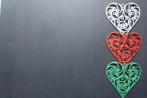 Three colored silver red fishnet colours on a black background with a copyspace spot for the Valentine's Day text photo