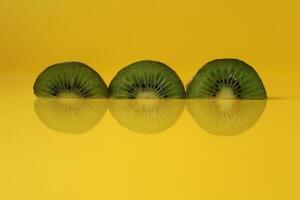 pieces of kiwi halves with a trend of Illuminating yellow color with a place to insert a copyspace photo