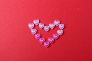 heart of rhinestone hearts on a red bright background with a copy of the space place for text valentine's day photo