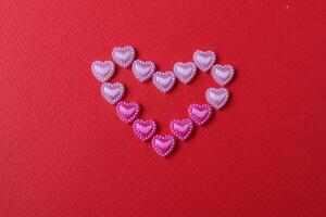 heart of rhinestone hearts on a red bright background with a copy of the space place for text valentine's day photo
