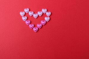 heart of rhinestone hearts on a red bright background with a copy of the space place for text valentine's day photo
