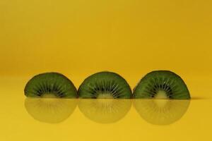 pieces of kiwi halves with a trend of Illuminating yellow color with a place to insert a copyspace photo