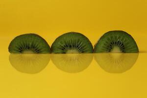 pieces of kiwi halves with a trend of Illuminating yellow color with a place to insert a copyspace photo