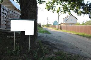 mock up stand signboard in the countryside dacha village near the wooden house photo