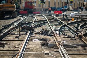 Construction site with scattered beams and rails, major tram track and asphalt replacement photo