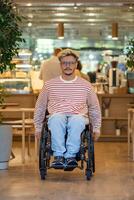 Calm man with disability in wheelchair moves around coffeeshop. Accessible environment for everyone. photo