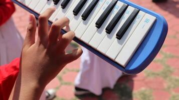 Close up Hand playing pianica photo