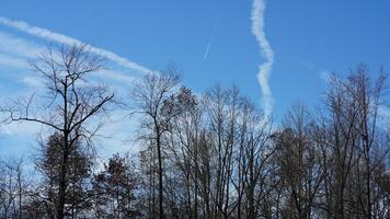 The blue sky view with the flying trail by the aircraft photo