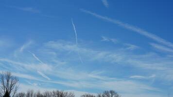 The blue sky view with the flying trail by the aircraft photo