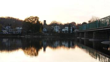 One old rion frames bridge view on the river with the sunset sky as background photo