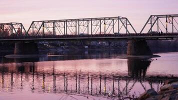 One old rion frames bridge view on the river with the sunset sky as background photo