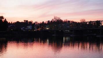 One old rion frames bridge view on the river with the sunset sky as background photo