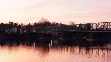 One old rion frames bridge view on the river with the sunset sky as background photo