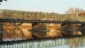 One old rion frames bridge view on the river with the sunset sky as background photo