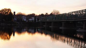 One old rion frames bridge view on the river with the sunset sky as background photo
