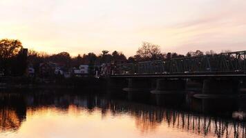One old rion frames bridge view on the river with the sunset sky as background photo