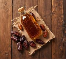 Dates sauce in bottle with dry dates photo
