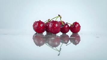A group of cherries on a table with water droplets photo