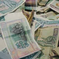 a pile of money with different currencies photo