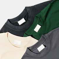 three different colored t - shirts on a white surface photo