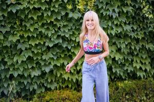 Happy dancer smiling while dancing next to an urban garden photo