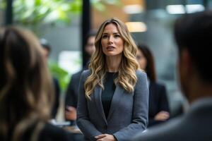 Woman leader addresses team in standing meeting at modern office photo