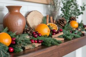 Festive Arrangement of Oranges, Cranberries, and Cinnamon on a Wooden Mantel photo