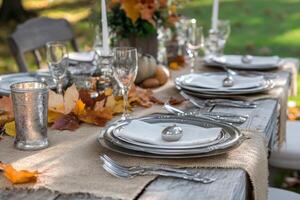 Silverware and Fall Leaves on a Rustic Table Setting photo