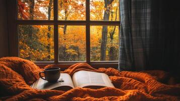 Autumnal Window View with Open Book and Mug of Coffee photo