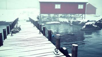Snowy Dock With Red House on Norwegian Sea video