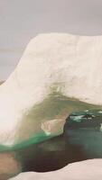 A large iceberg floating on top of a body of water video