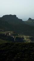 A view of a mountain with a few rocks in the distance video