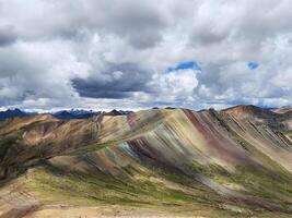 A mountain range with many different colored hills photo