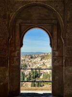 A view of the city through an arched window photo
