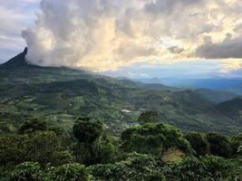 A view of the mountains and clouds from a hill photo