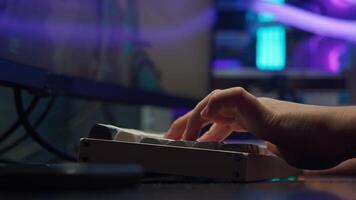 close-up of the fingers of the left hand of a gamer playing an online shooter on a computer using the keyboard video