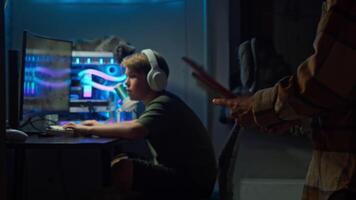Father and child have agreed on the amount of time son is allowed to play computer games. After this, son will need to complete his homework. video
