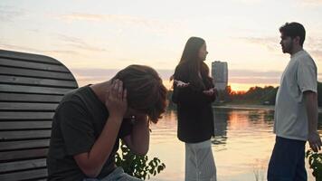 Conflict in a young family, which took place in a public setting, resulted in the son covering his ears with his hands in order to block out the sounds of the argument. video