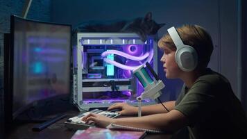 Teenage boy was extremely pleased with the successful outcome of an online shooting game, which he played on his gaming computer in the evening at home. video
