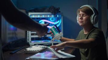 One of the parents pressures the child into doing homework instead of allowing them to have fun at the gaming computer. Slow motion video