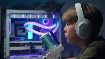 Teenage guy was super stoked about the great score he got in an online shooter game he played on his PC at home in the evening. Close up video